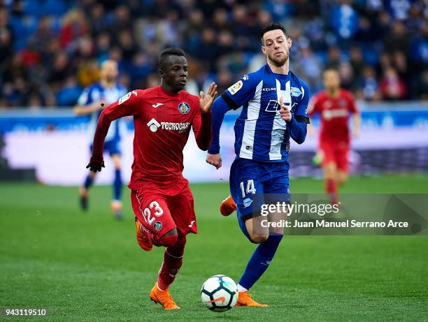 Amath Ndiaye of Getafe CF duels for the ball with Jorge Franco 'Burgui' of Deportivo Alaves during the La Liga match between Deportivo Alaves and...