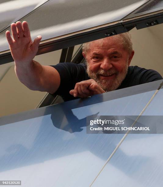 Brazilian former president Luiz Inacio Lula da Silva waves from a window of the Metallurgical Union, in Sao Bernardo do Campo, Sao Paulo state,...