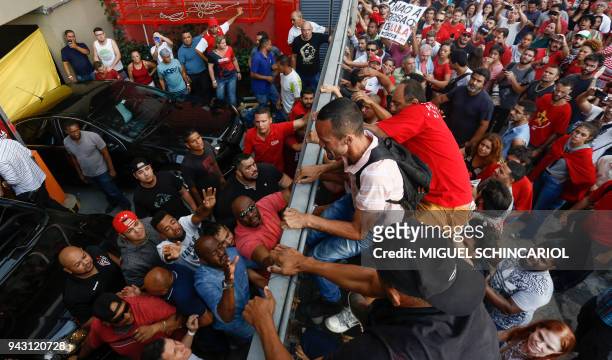 Supporters of Brazilian former president Luiz Inacio Lula da Silva block the entrance of the Metallurgical Union building garage exit in Sao Bernardo...