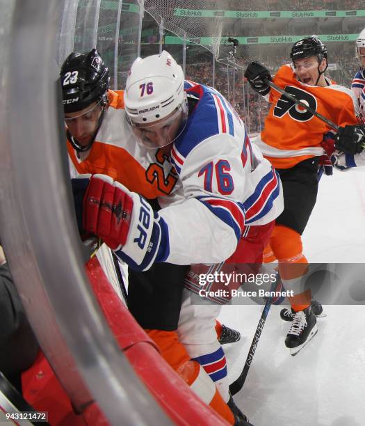 Brady Skjei of the New York Rangers holds Brandon Manning of the Philadelphia Flyers against the glass during the second period at the Wells Fargo...