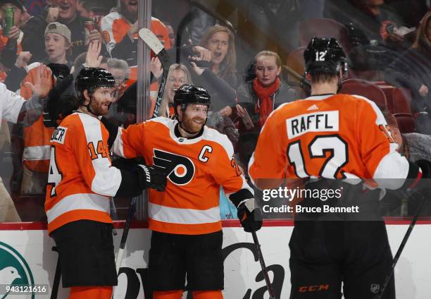 Claude Giroux of the Philadelphia Flyers celebrates his goal at 17:59 of the second period against the New York Rangers and is joined by Sean...