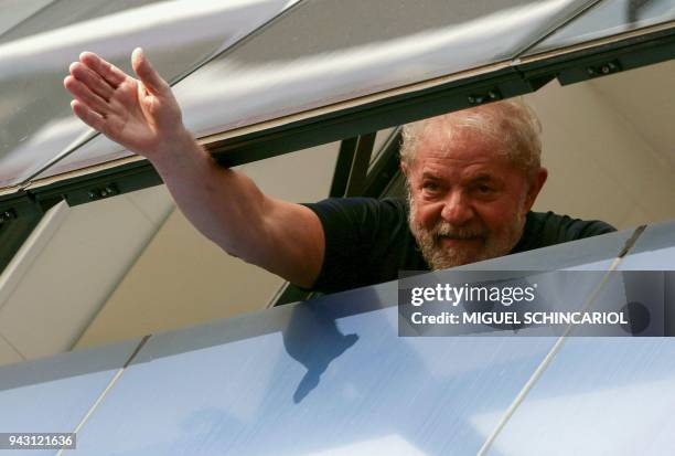 Brazilian former president Luiz Inacio Lula da Silva waves from a window of the Metallurgical Union, in Sao Bernardo do Campo, Sao Paulo state,...