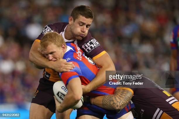 Slade Griffin of the Knights is tackled during the round five NRL match between the Newcastle Knights and the Brisbane Broncos at McDonald Jones...