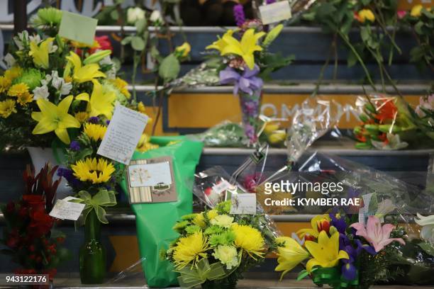 Flowers are left outside the Humboldt Uniplex ice-skating rink on April 7, 2018 in Humboldt, Saskatchewan after a bus carrying a junior ice hockey...