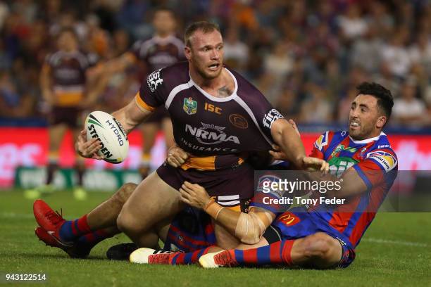 Matthew Lodge of the Broncos is tackled by Brock Lamb of the Knights during the round five NRL match between the Newcastle Knights and the Brisbane...