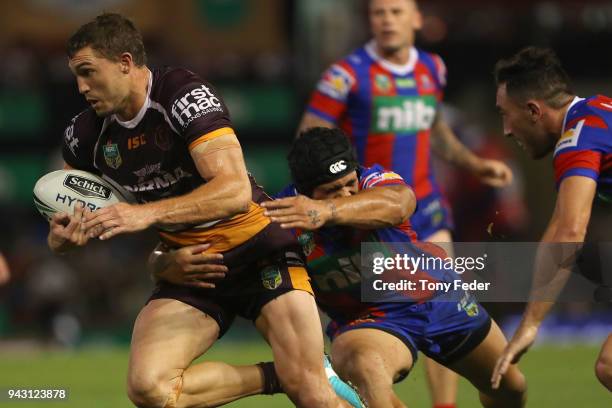 Corey Oates of the Broncos is tackled during the round five NRL match between the Newcastle Knights and the Brisbane Broncos at McDonald Jones...