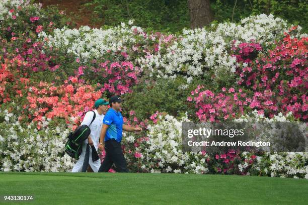 Patrick Reed of the United States and caddie Kessler Karain walk on the 13th hole during the third round of the 2018 Masters Tournament at Augusta...