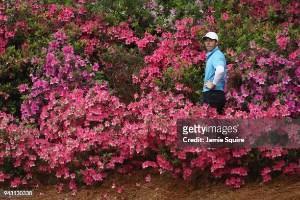Rory McIlroy of Northern Ireland prepares to play a shot out of the flowers on the 13th hole during the third round of the 2018 Masters Tournament at...