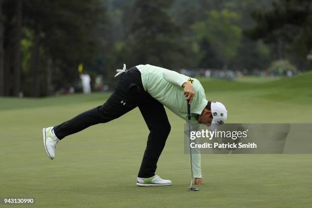 Bernd Wiesberger of Austria picks up his ball on the eighth green during the third round of the 2018 Masters Tournament at Augusta National Golf Club...