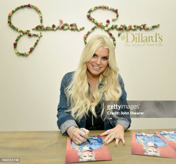 Jessica Simpson autographs photos for fans during a spring style event for army wives and kids in Dillards at The Mall at Green Hills hosted by...