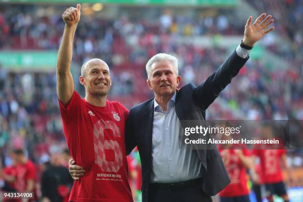 Jupp Heynckes, head coach of Bayern Muechen, celebrates in front of their supporters with Arjen Robben of Bayern Muenchen winning the 6th...