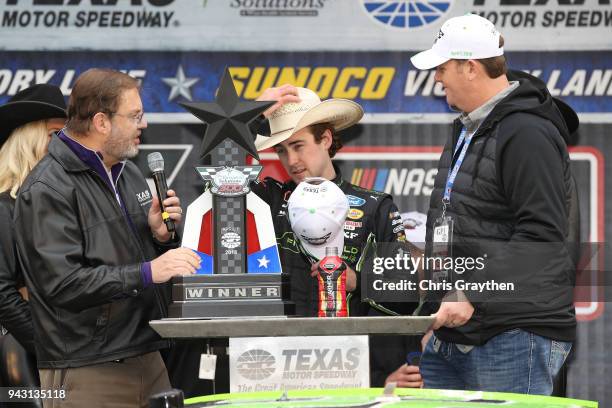 Ryan Blaney, driver of the Fitzgerald Glider Kits Ford, celebrates with the trophy in Victory Lane after winning the NASCAR Xfinity Series My...