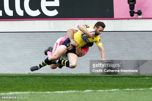 Greig Laidlaw of ASM Clermont Auvergne is tackled by Willem Alberts of Stade Francais Paris during the French Top 14 match between Stade Francais...