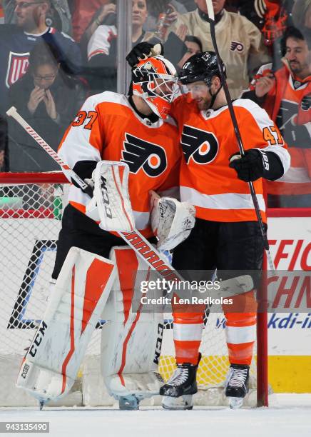 Brian Elliott and Andrew MacDonald of the Philadelphia Flyers celebrate after defeating the New York Rangers 5-0 on April 7, 2018 at the Wells Fargo...