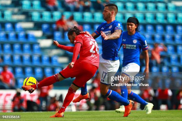Edgar Mendez of Cruz Azul struggles for the ball with Carlos Morales of Lobos BUAP during the 14th round match between Cruz Azul and Lobos BUAP as...