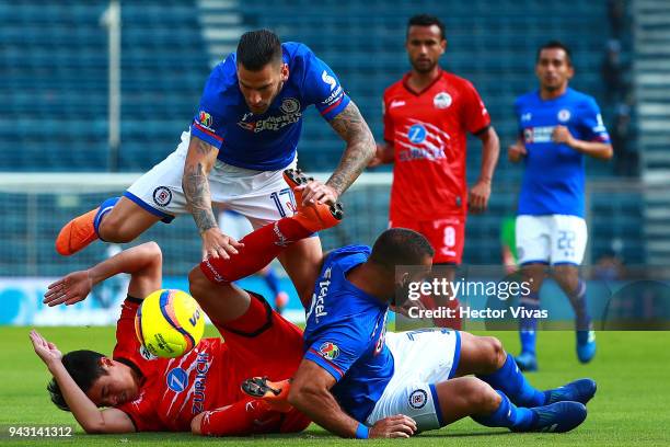Edgar Mendez and Martin Cauteruccio of Cruz Azul struggle for the ball with Eduardo Tercero of Lobos BUAP during the 14th round match between Cruz...