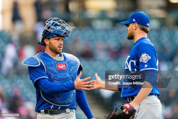 Catcher Drew Butera celebrates with relief pitcher Justin Grimm of the Kansas City Royals after retiring the eighth inning against the Cleveland...