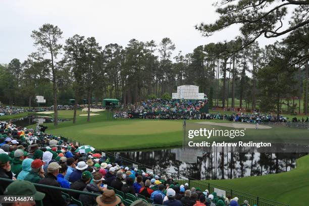 Patrick Reed of the United States chips in for eagle on the 15th green during the third round of the 2018 Masters Tournament at Augusta National Golf...