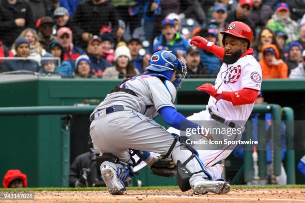 Washington Nationals left fielder Brian Goodwin is thrown out at the plate as New York Mets catcher Travis d'Arnaud applies the second inning tag...