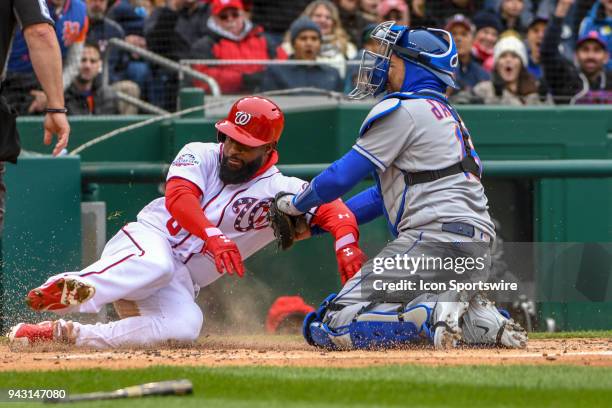 Washington Nationals left fielder Brian Goodwin is thrown out at the plate as New York Mets catcher Travis d'Arnaud applies the second inning tag...