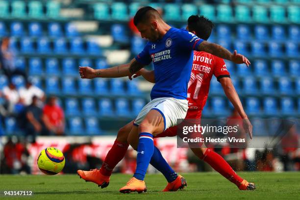 Edgar Mendez of Cruz Azul struggles for the ball with Eduardo Tercero of Lobos BUAP during the 14th round match between Cruz Azul and Lobos BUAP at...