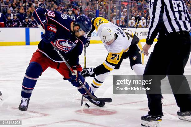 Boone Jenner of the Columbus Blue Jackets and Evgeni Malkin of the Pittsburgh Penguins battle for control of the puck during a face-off on April 5,...