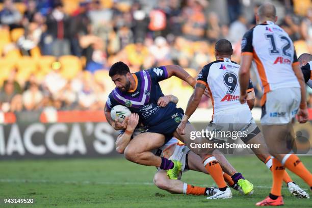 Jesse Bromwich of the Storm is tackled during the round five NRL match between the Wests Tigers and the Melbourne Storm at Mt Smart Stadium on April...