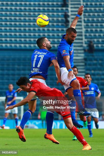 Edgar Mendez and Martin Cauteruccio of Cruz Azul struggles for the ball with Eduardo Tercero of Lobos BUAP during the 14th round match between Cruz...