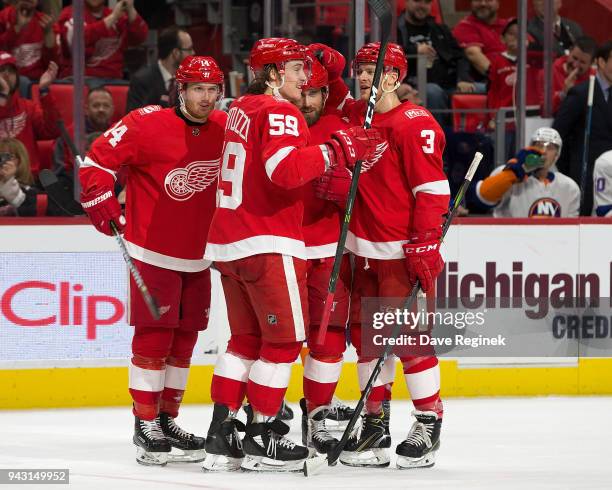 Henrik Zetterberg of the Detroit Red Wings celebrates his first period goal with teammates Gustav Nyquist, Tyler Bertuzzi and Nick Jensen during an...