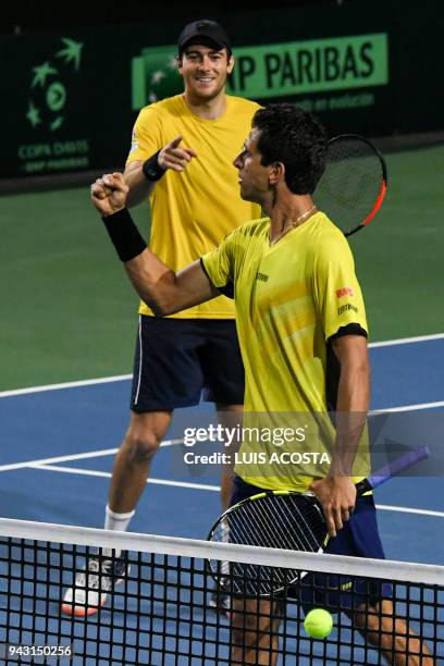 Brazilian tennis player Marcelo Melo celebrates with his teammate Marcelo Demoliner after defeating Colombian tennis players Juan Sebastian Cabal and...