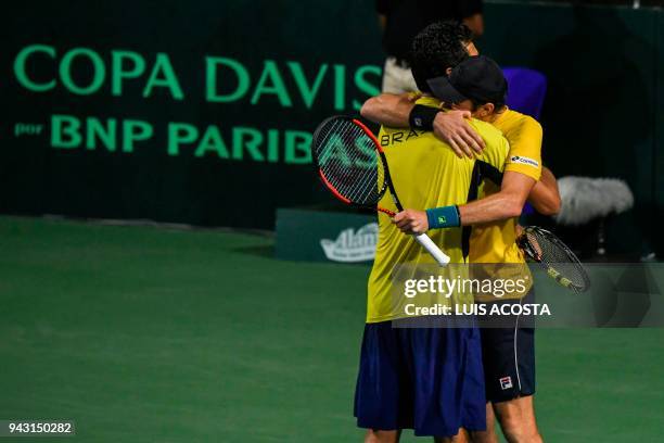 Brazilian tennis player Marcelo Melo celebrates with his teammate Marcelo Demoliner after defeating Colombian tennis players Juan Sebastian Cabal and...