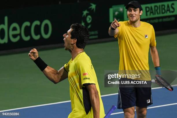 Brazilian tennis player Marcelo Melo celebrates with his teammate Marcelo Demoliner after defeating Colombian tennis players Juan Sebastian Cabal and...