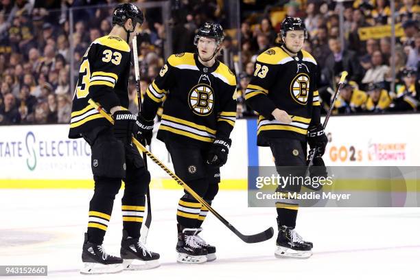 Zdeno Chara of the Boston Bruins, Danton Heinen and Charlie McAvoy talk during the first period against the Ottawa Senators at TD Garden on April 7,...