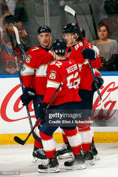 Colton Sceviour of the Florida Panthers celebrates his goal with teammates Henrik Borgstrom and MacKenzie Weegar against the Buffalo Sabres at the...