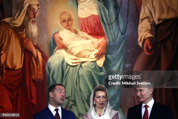 Russian President Vladimir Putin , Prime Minister Dmitry Medvedev and his wife Svetlana Medvedeva smile during the Orthodox Easter service in the...