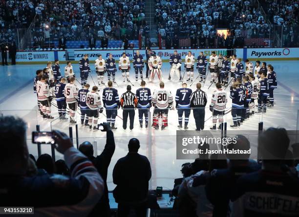 Winnipeg Jets and Chicago Blackhawks players honour those involved in the Humboldt Broncos bus crash tragedy before NHL action on April 7, 2018 at...