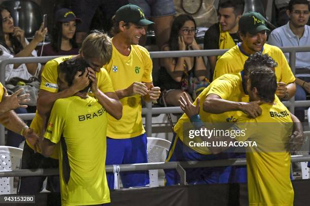 Brazilian tennis player Marcelo Melo and Marcelo Demoliner celebrate with their teammates after defeating Colombian tennis players Juan Sebastian...