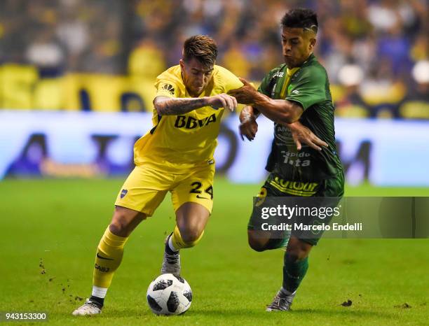 Julio Buffarini of Boca Juniors fights for the ball with Nicolas Fernandez of Defensa y Justicia during a match between Boca Juniors and Defensa y...