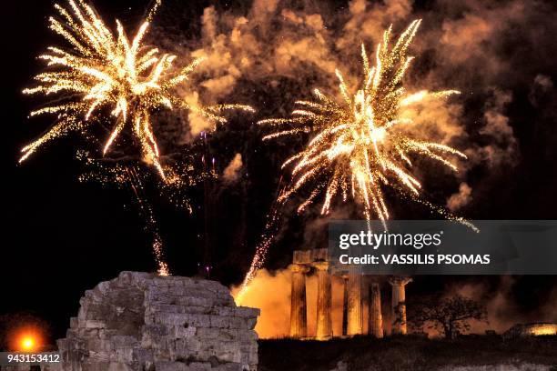 This photo taken on April 7, 2018 shows fireworks exploding over the archaeological temple of Apollo in ancient Corinth near Athens as Greek Orthodox...