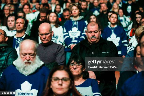 Toronto Maple Leaf fans bow their heads in a moment of silence to for the victims of hockey team bus tragedy the day before. A bus carrying the...