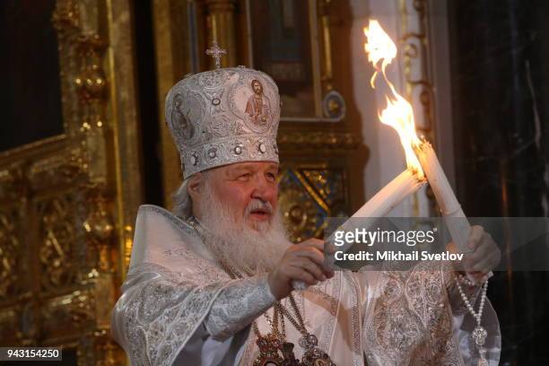 Russian Orthodox Patriarch Kirill lights candles during the Orthodox Easter service in the Christ the Saviour Cathedral in Central Moscow,...