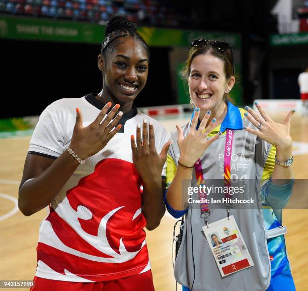 Erin Aumann a photo volunteer poses with Melita Emanuel-Carr of England as they show their painted nails before the start of the Preliminary...