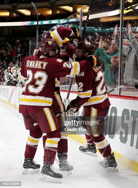 Jared Thomas of the Minnesota-Duluth Bulldogs celebrates his goal with teammate Nick Swaney in the first period against the Notre Dame Fighting Irish...