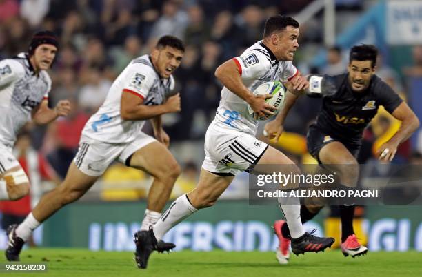 New Zealand's Crusaders centre Ryan Crotty runs to score past Argentina's Jaguares centre Jeronimo De La Fuente during their Super Rugby match at...