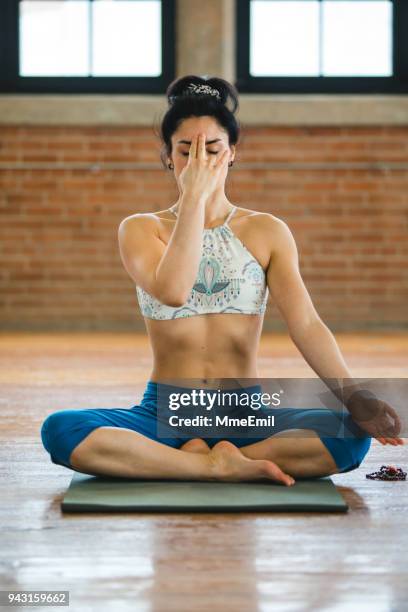 pranayama breathing exercises. woman practicing yoga position - pranayama stock pictures, royalty-free photos & images