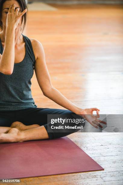 woman practicing yoga position. pranayama breathing exercises - pranayama stock pictures, royalty-free photos & images