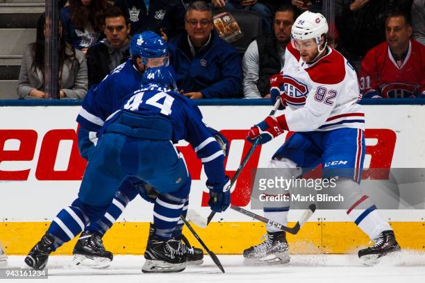 Jonathan Drouin of the Montreal Canadiens skates against Morgan Rielly and Ron Hainsey of the Toronto Maple Leafs during the first period at the Air...