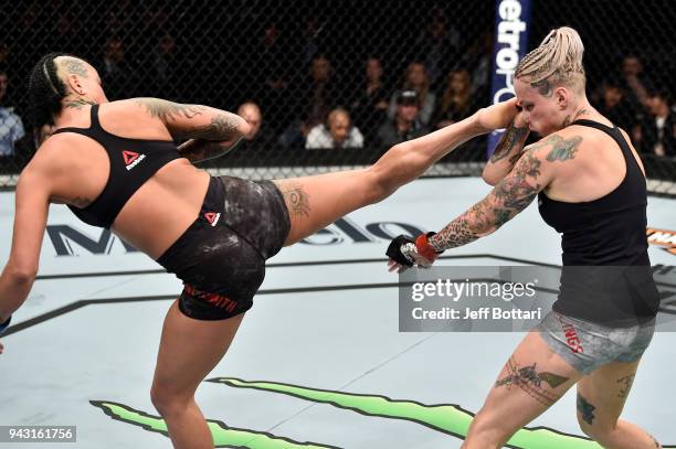 Ashlee Evans-Smith kicks Bec Rawlings of Australia in their women's flyweight bout during the UFC 223 event inside Barclays Center on April 7, 2018...