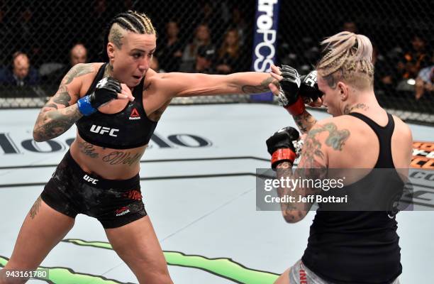 Ashlee Evans-Smith punches Bec Rawlings of Australia in their women's flyweight bout during the UFC 223 event inside Barclays Center on April 7, 2018...