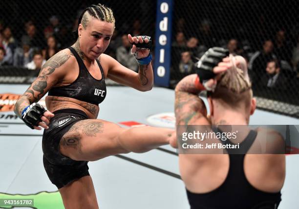 Ashlee Evans-Smith kicks Bec Rawlings of Australia in their women's flyweight bout during the UFC 223 event inside Barclays Center on April 7, 2018...